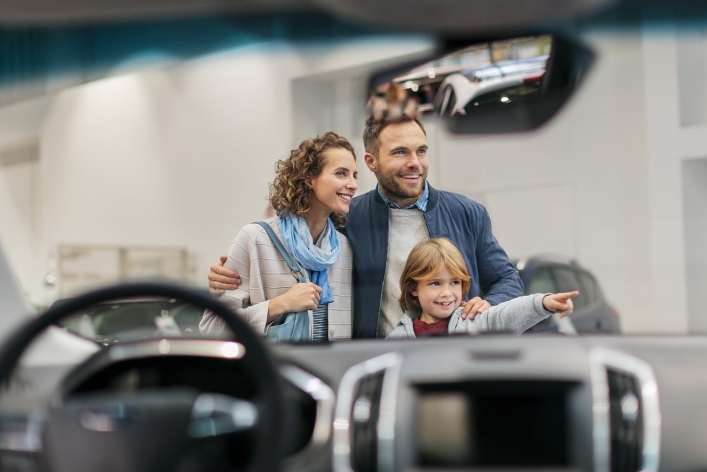 Family looking at a car