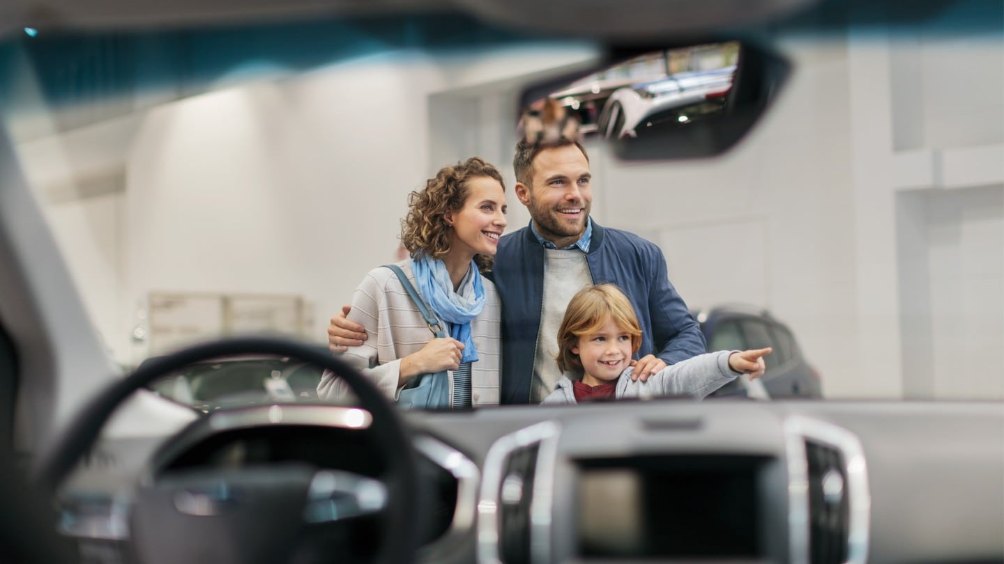 Family looking at a car