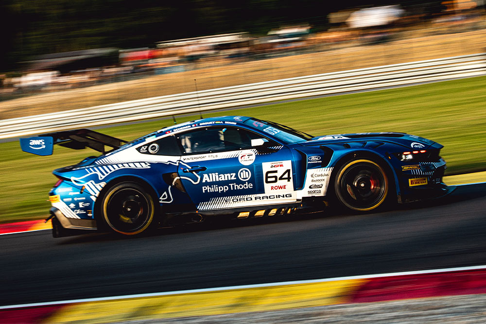 Una Ford GT aerodinamica con grande alettone posteriore sfreccia in pista.