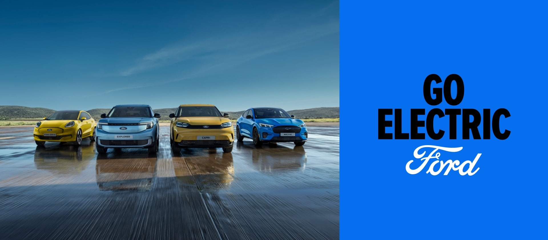 Ford Puma Gen-E, Ford Explorer, Ford Capri e Ford Mustang Mach-E schierati su una pista, accanto a un grafico Go Electric su sfondo blu.