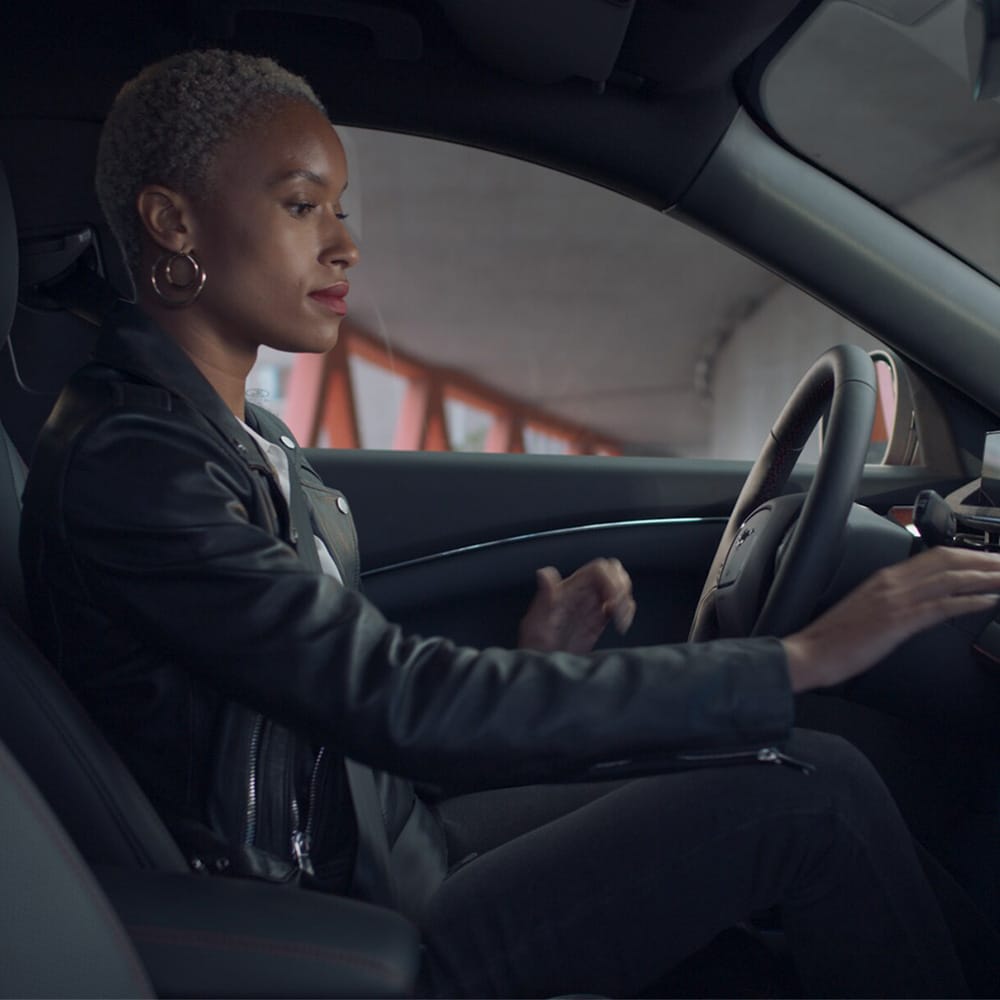 Woman in a Ford Mustang Mach-E reaching to dashboard
