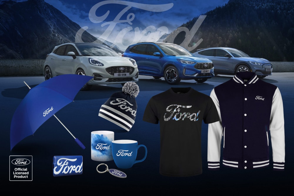 Ford merchandise collection featuring various Ford vehicles in the background with Ford branded umbrella, mugs, and clothing items.