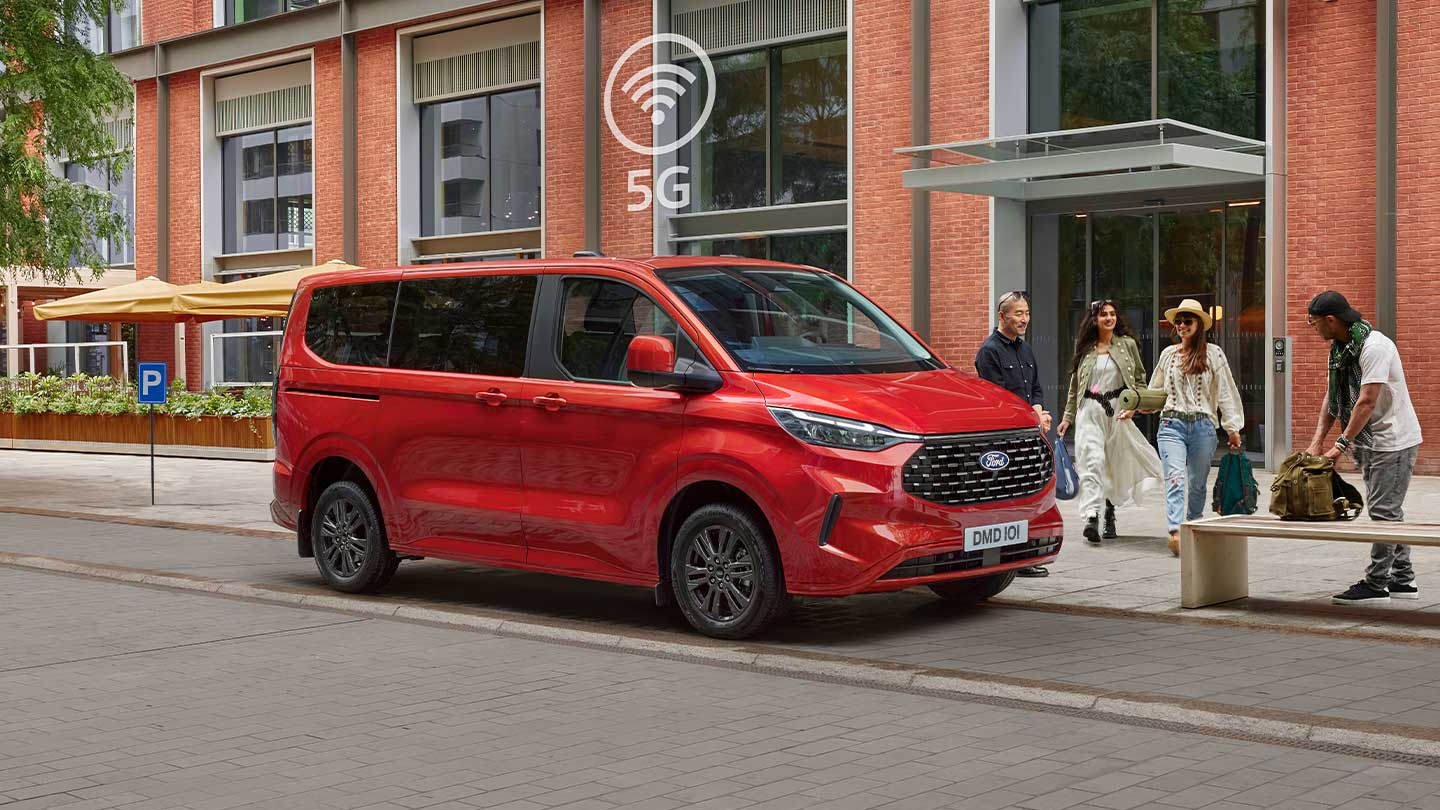 Nuovissimo Tourneo Custom rosso parcheggiato con persone intorno