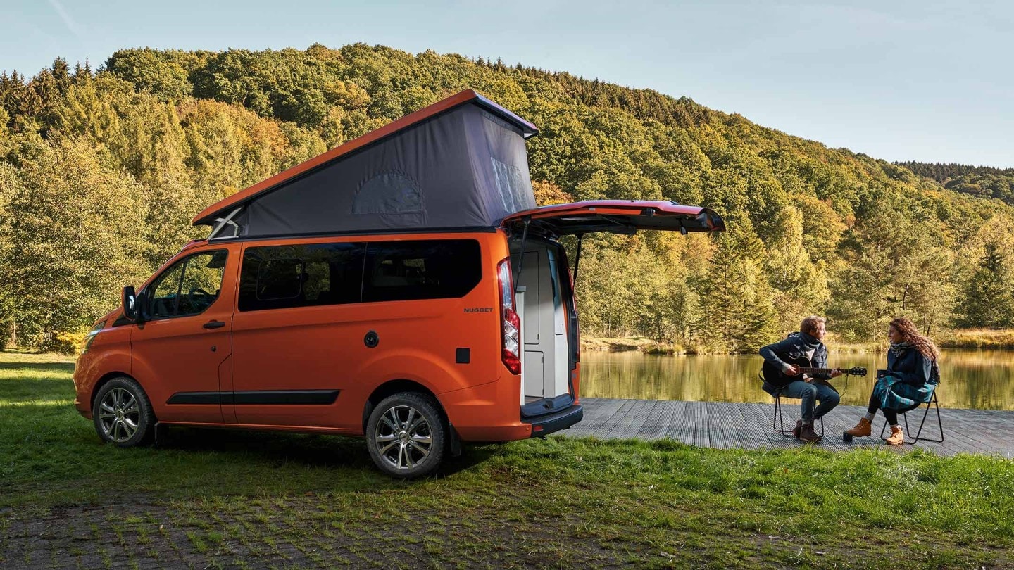 Orange Ford Transit Custom Nugget side view with raised roof