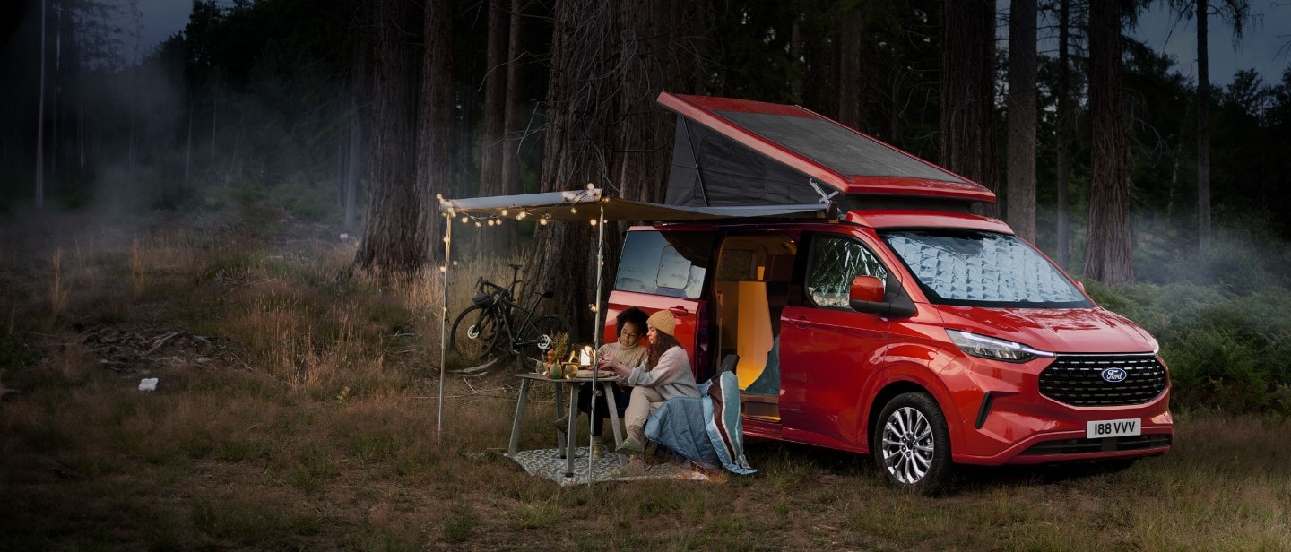 All-New Ford Transit Custom Nugget in forest with people camping All-New Ford Transit Custom Nugget in forest with people camping