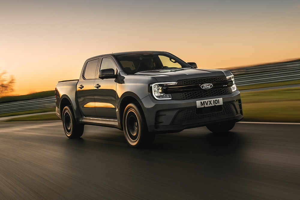Un Ford Ranger Platinum grigio scuro percorre una pista al tramonto.