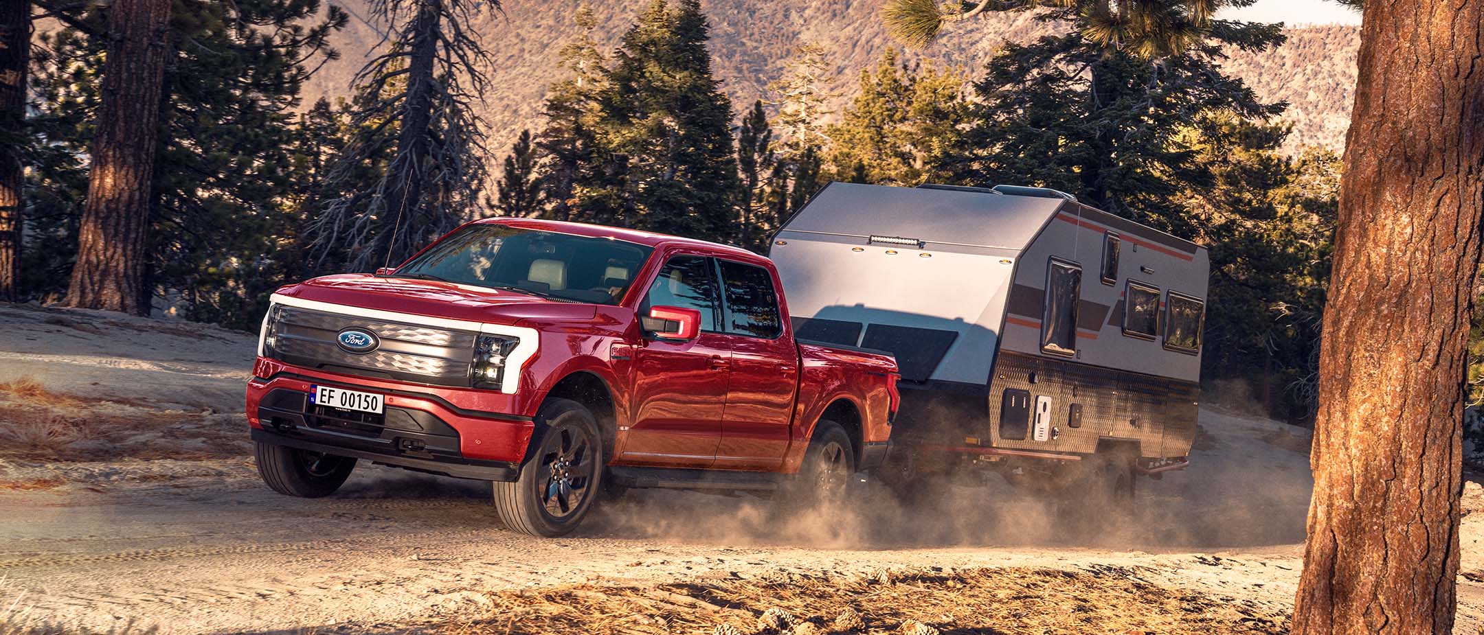 Ford F-150 Lightning towing caravan in a wild.