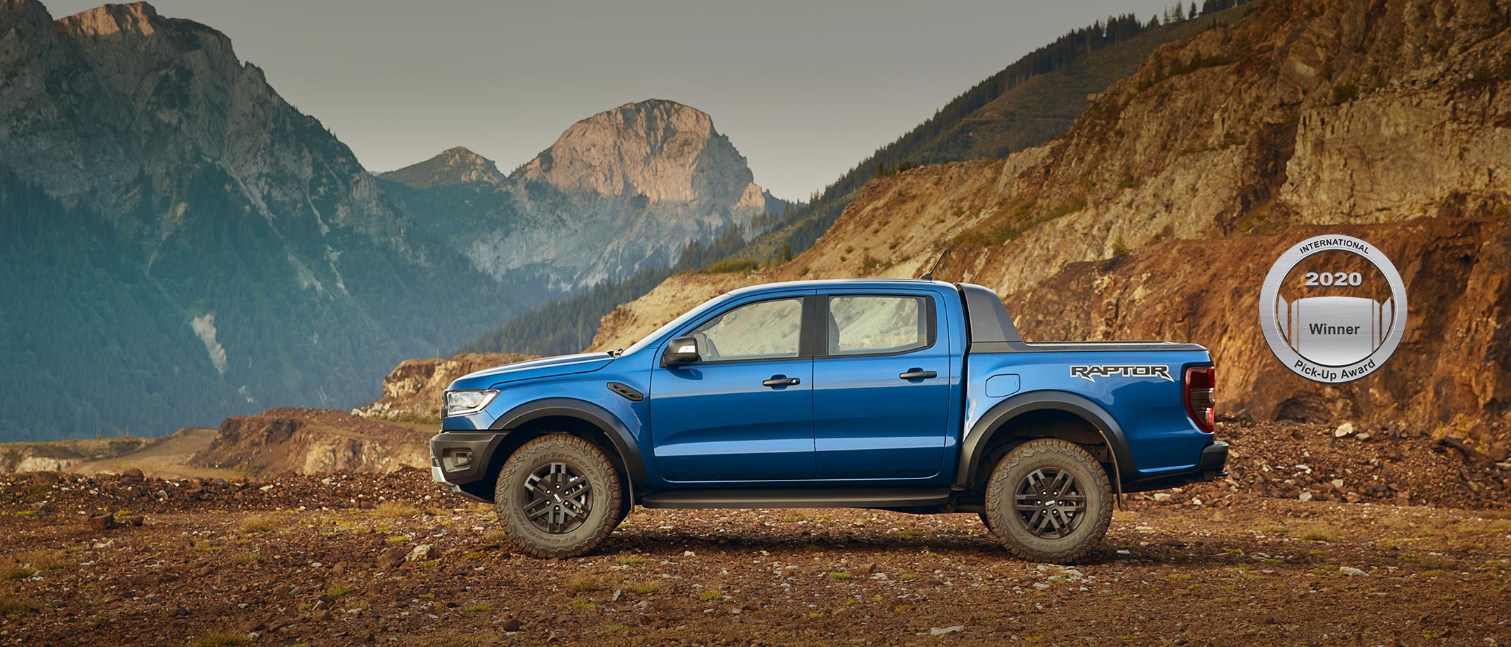 Ranger Raptor parked with mountains backdrop